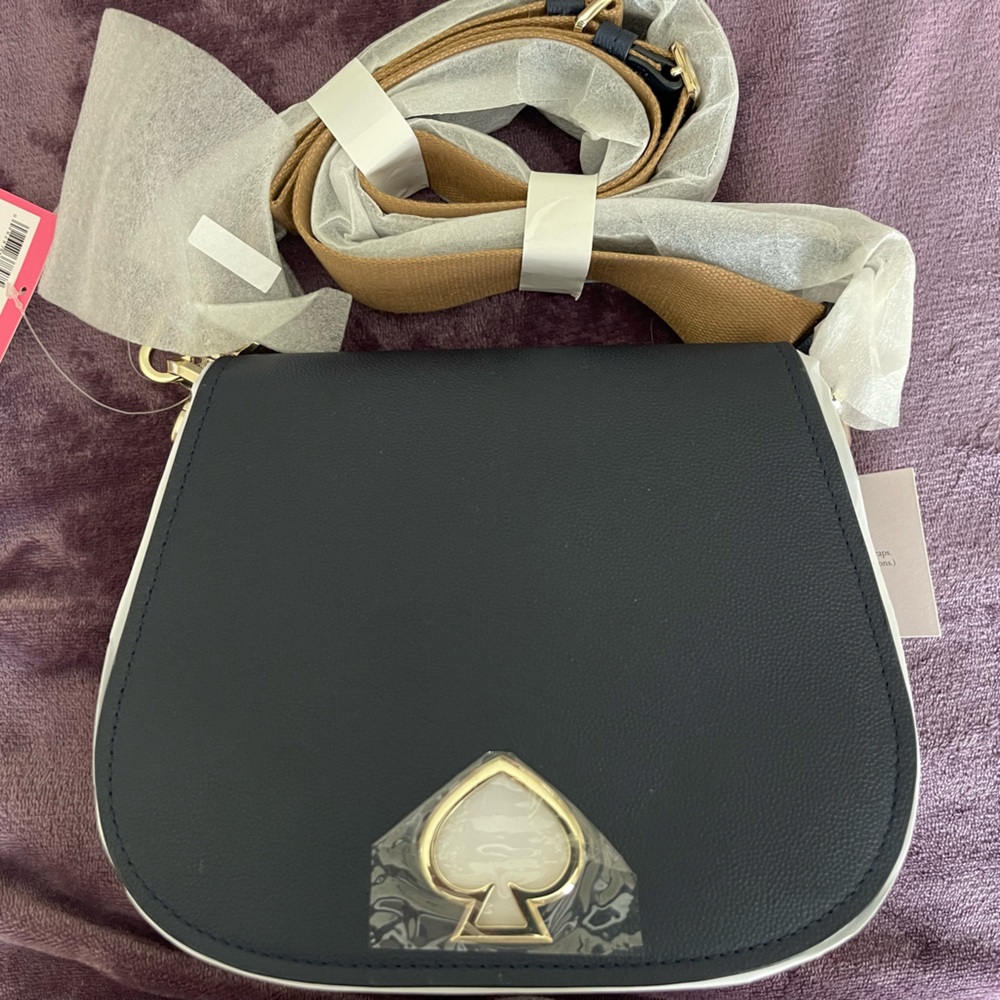 Authentic navy blue Kate Spade handbag. New with tags. Suzy large saddle.